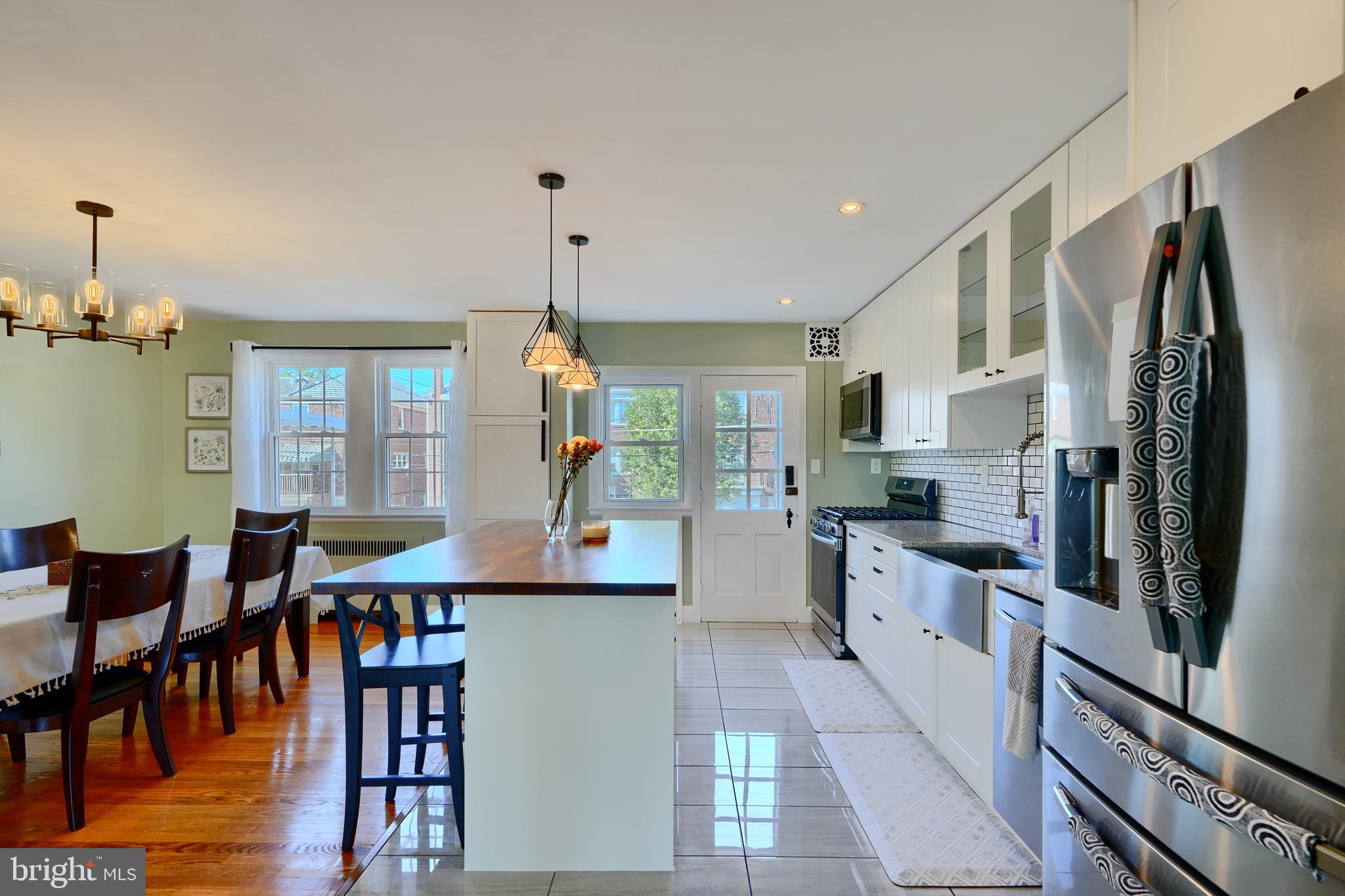 428 Overbrook Road Baltimore, MD 21228 - Photo 12 of 59 a kitchen with stainless steel appliances granite countertop a refrigerator a stove and a dining table with wooden floor