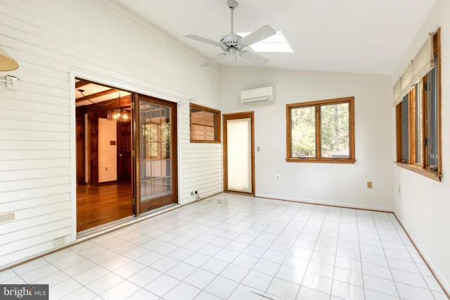 an empty room with windows and closet