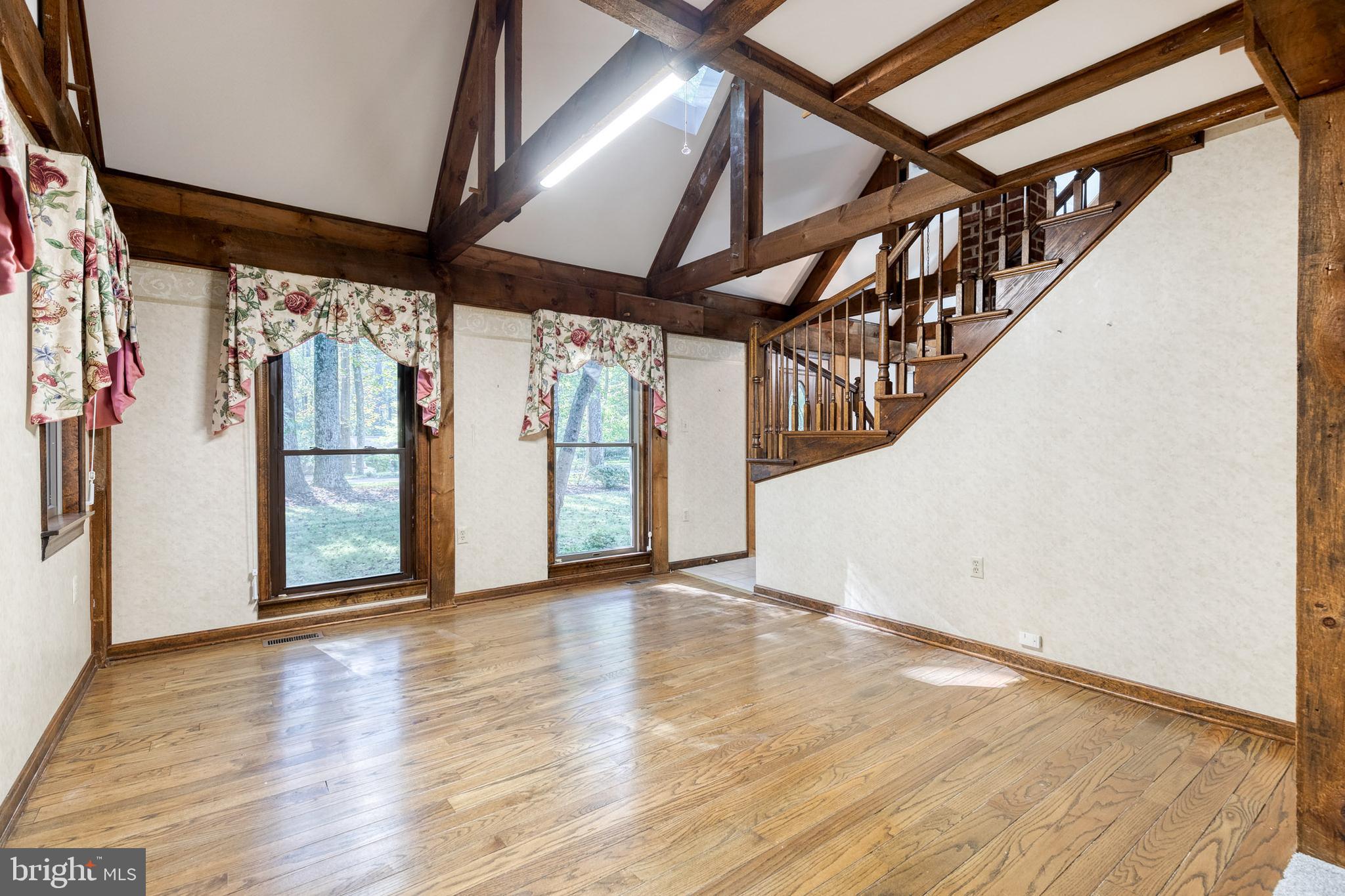 12610 Timber Grove Road Reisterstown, MD 21136 - Photo 14 of 39 a view of an empty room with wooden floor and door