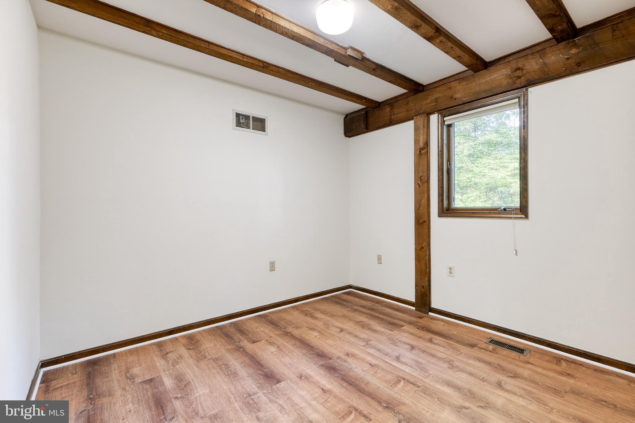 12610 Timber Grove Road Reisterstown, MD 21136 - Photo 21 of 39 a view of empty room with wooden floor