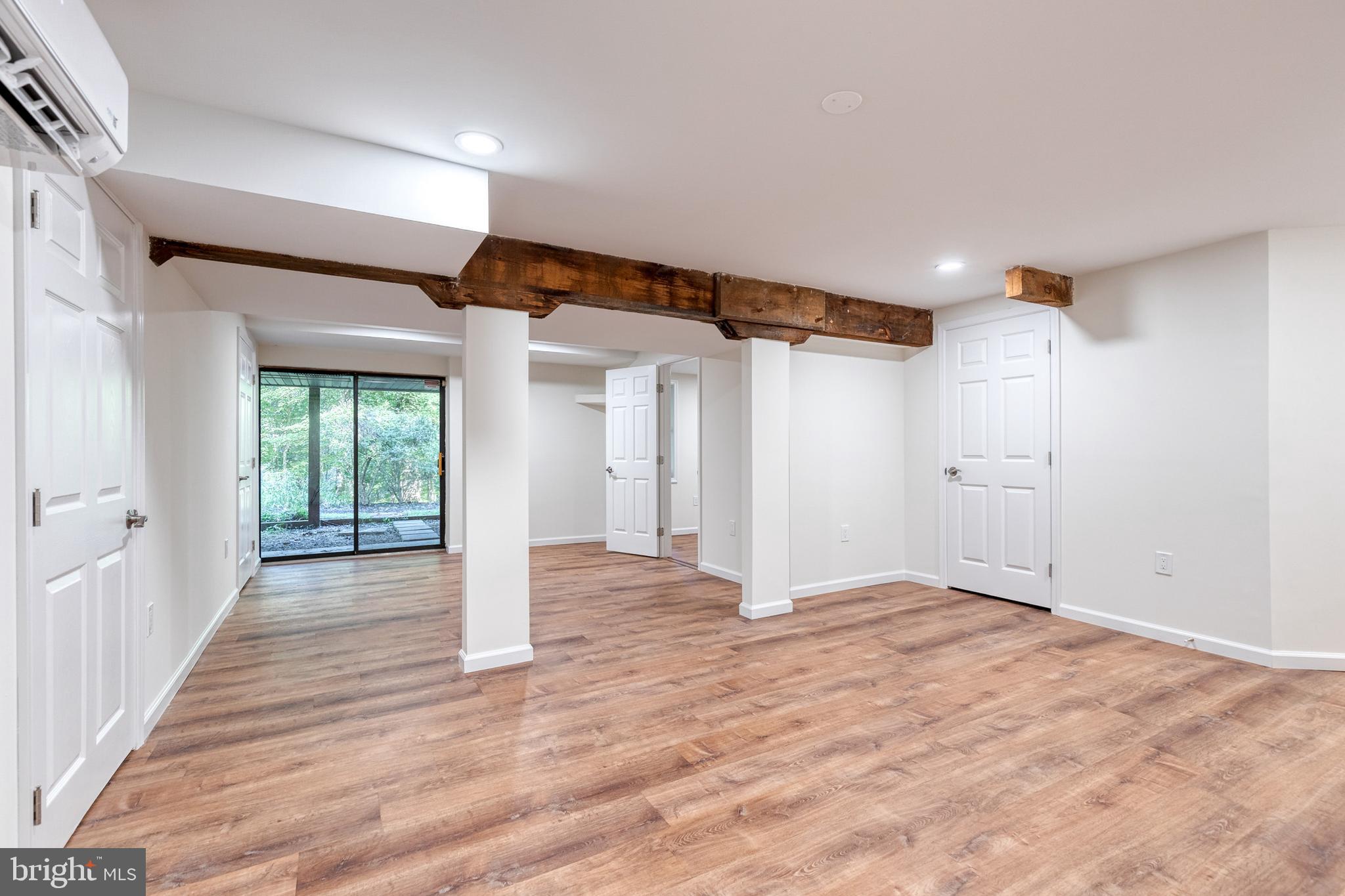 12610 Timber Grove Road Reisterstown, MD 21136 - Photo 23 of 39 a view of an empty room with wooden floor and a window