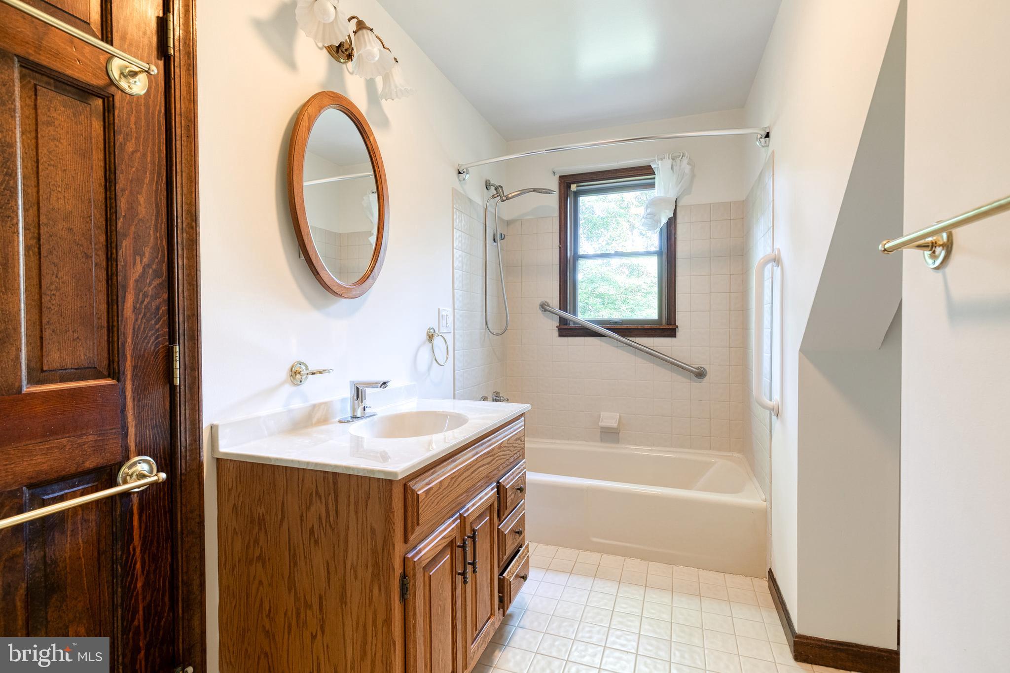 12610 Timber Grove Road Reisterstown, MD 21136 - Photo 31 of 39 a bathroom with a sink and a mirror