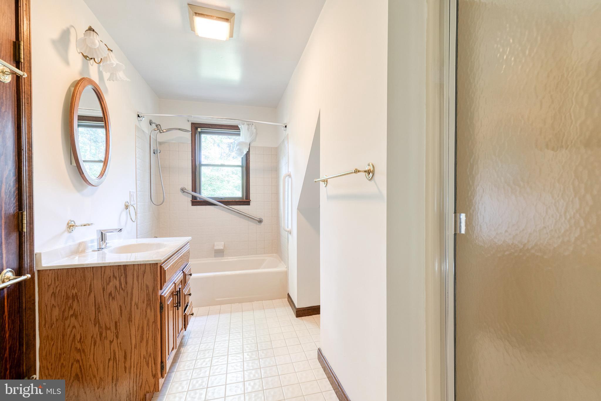 12610 Timber Grove Road Reisterstown, MD 21136 - Photo 34 of 39 a bathroom with a bathtub sink mirror and a toilet