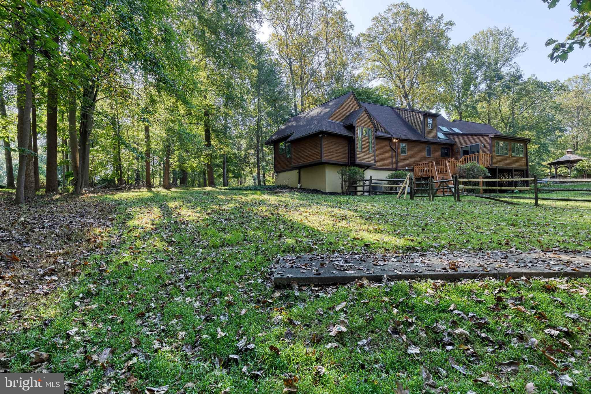 12610 Timber Grove Road Reisterstown, MD 21136 - Photo 35 of 39 a view of a house with a big yard and large trees