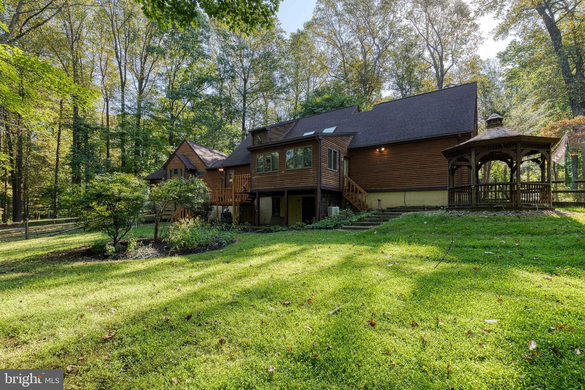 12610 Timber Grove Road Reisterstown, MD 21136 - Photo 39 of 39 a backyard of a house with barbeque oven and outdoor seating