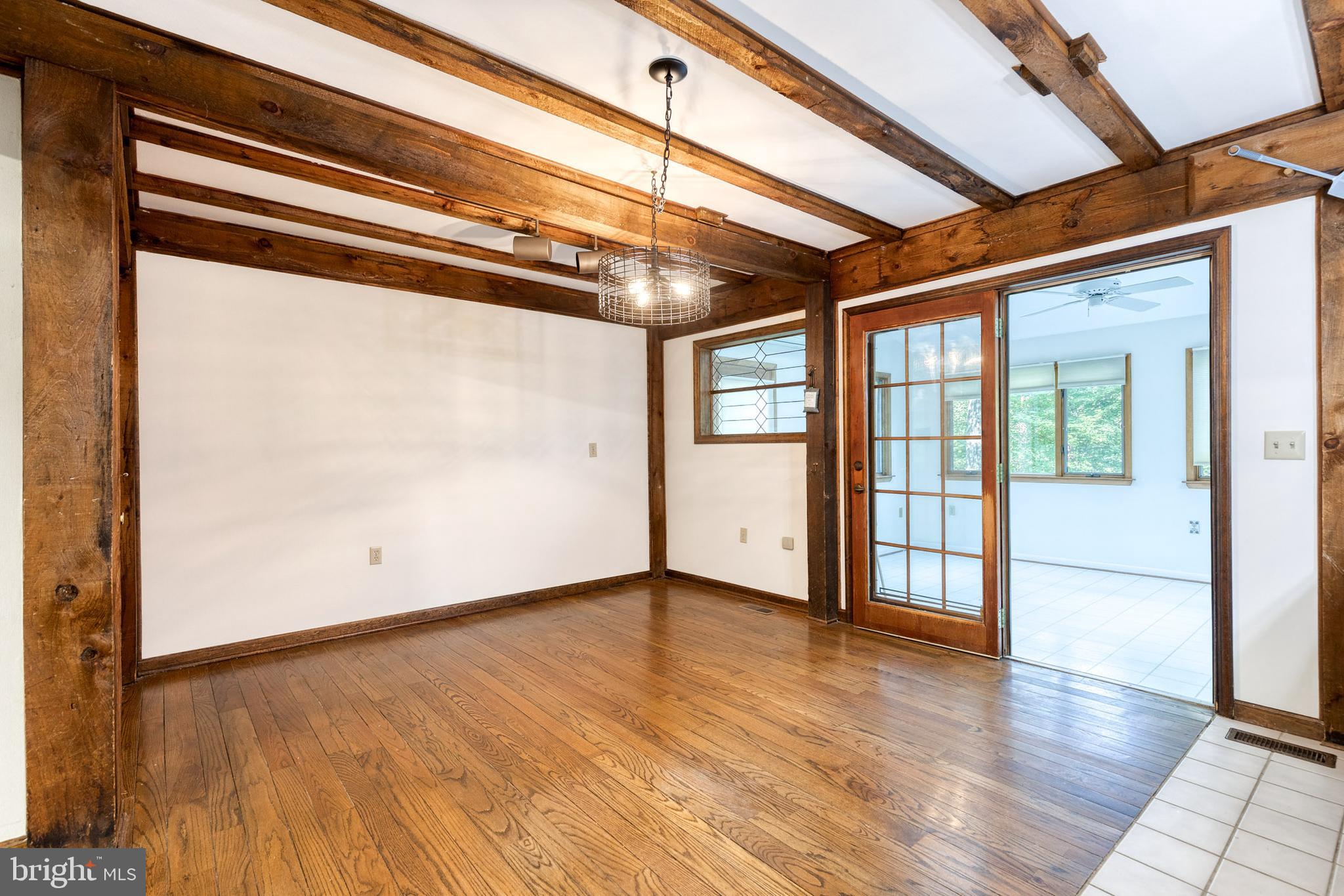 12610 Timber Grove Road Reisterstown, MD 21136 - Photo 7 of 39 a view of a room with wooden floor and windows