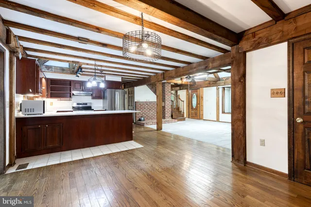 a kitchen with stainless steel appliances granite countertop a refrigerator a sink and a dishwasher