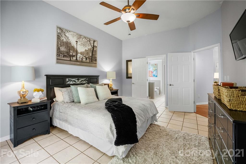 2832 Williams Station Road Matthews, NC 28105 - Photo 22 of 41 a bedroom with a bed and a chandelier