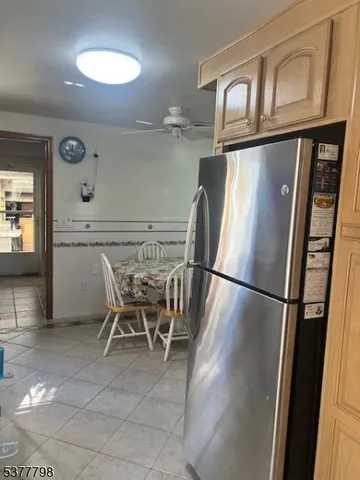 a view of a refrigerator and wooden floor