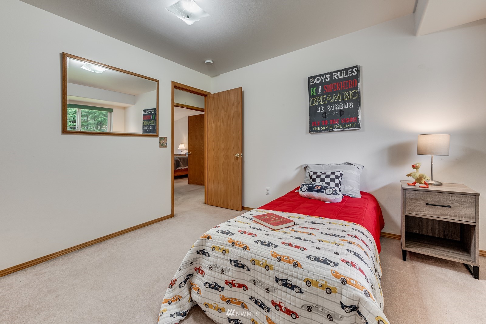 5531 East Wishon Road Snohomish, WA 98290 - Photo 16 of 36 a bedroom with a large bed and a chandelier