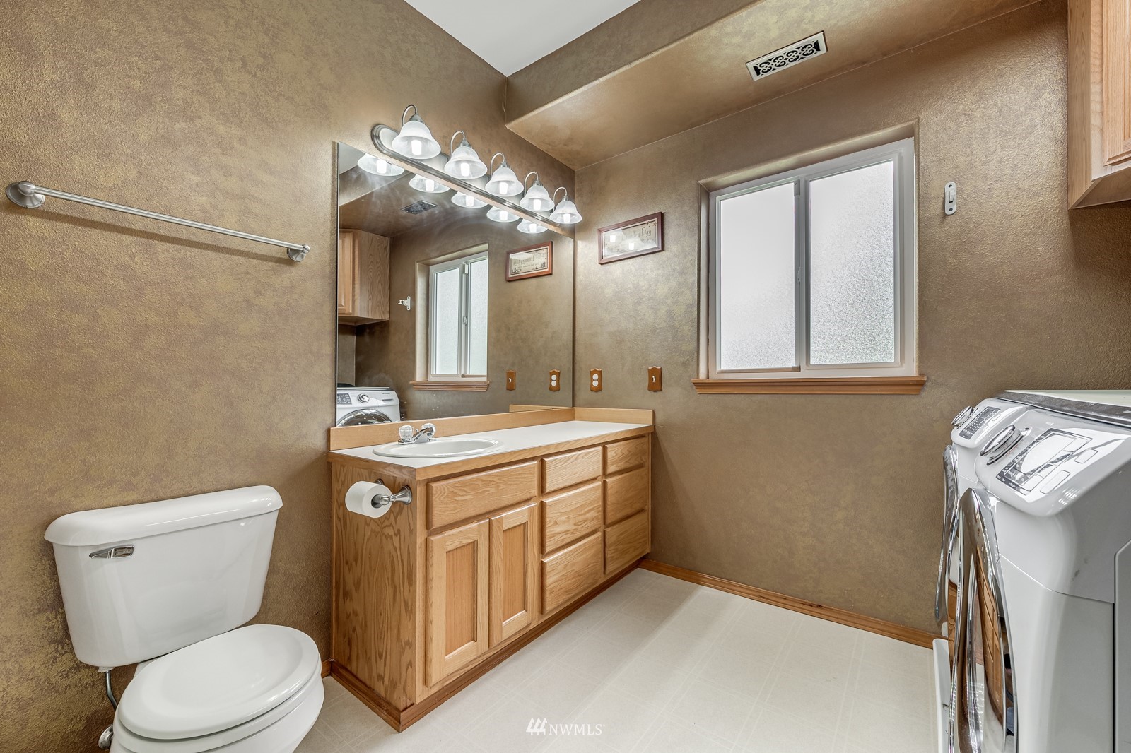 5531 East Wishon Road Snohomish, WA 98290 - Photo 27 of 36 a bathroom with a toilet sink and mirror