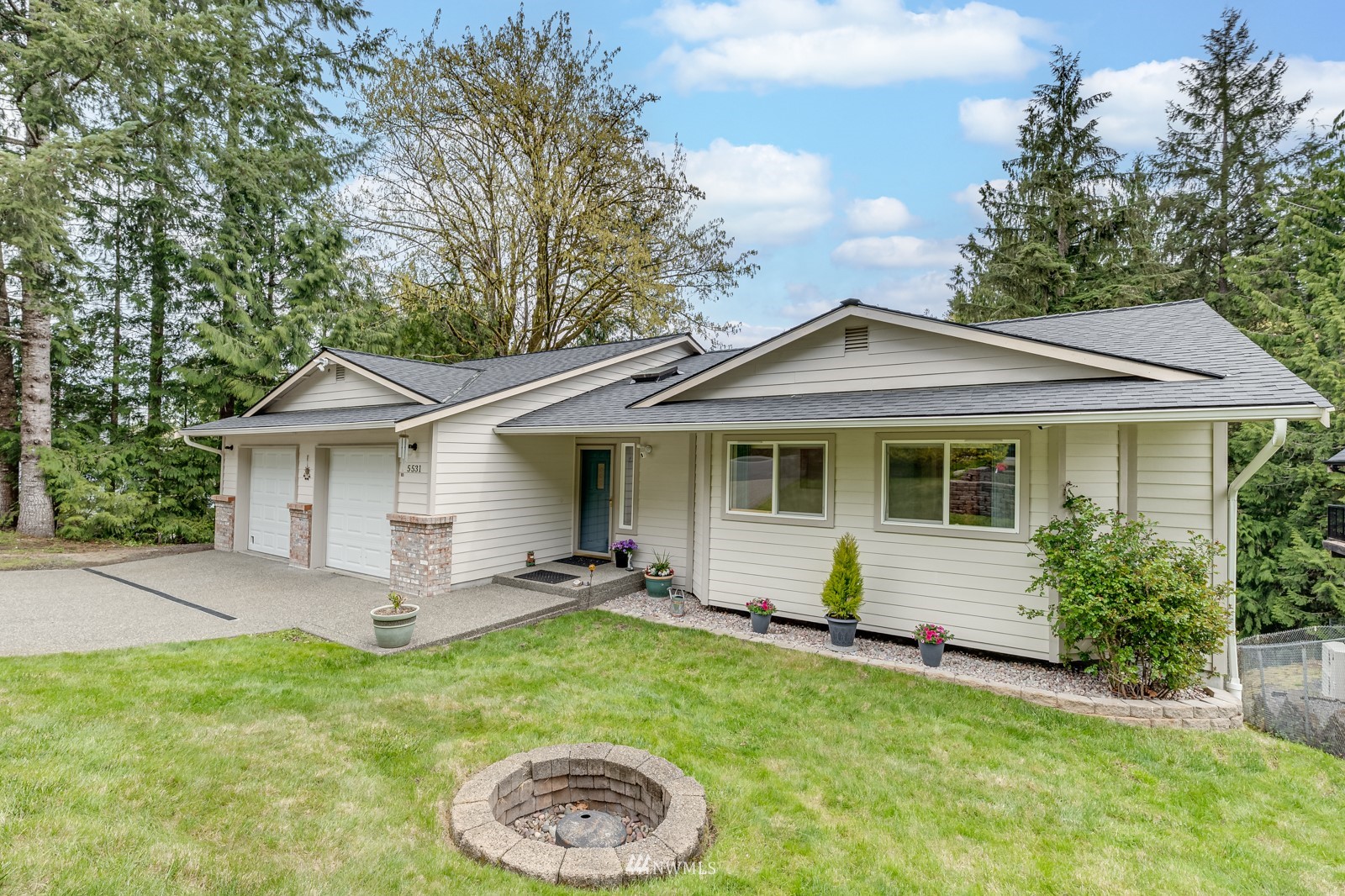 5531 East Wishon Road Snohomish, WA 98290 - Photo 35 of 36 a view of a house with a yard and potted plants