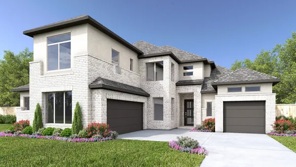 a front view of a house with a garden and yard