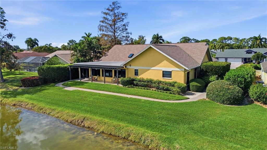2274 Queens Way Naples, FL 34112 - Photo 3 of 28 a front view of a house with a yard