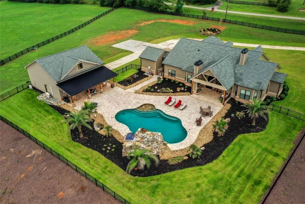 1044 Austin Road Winder, GA 30680 - Photo 1 of 1 an aerial view of a house with a garden and swimming pool