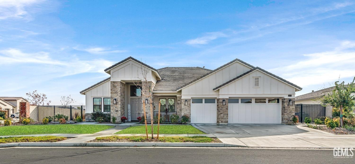 a view of a house next to a yard with big trees