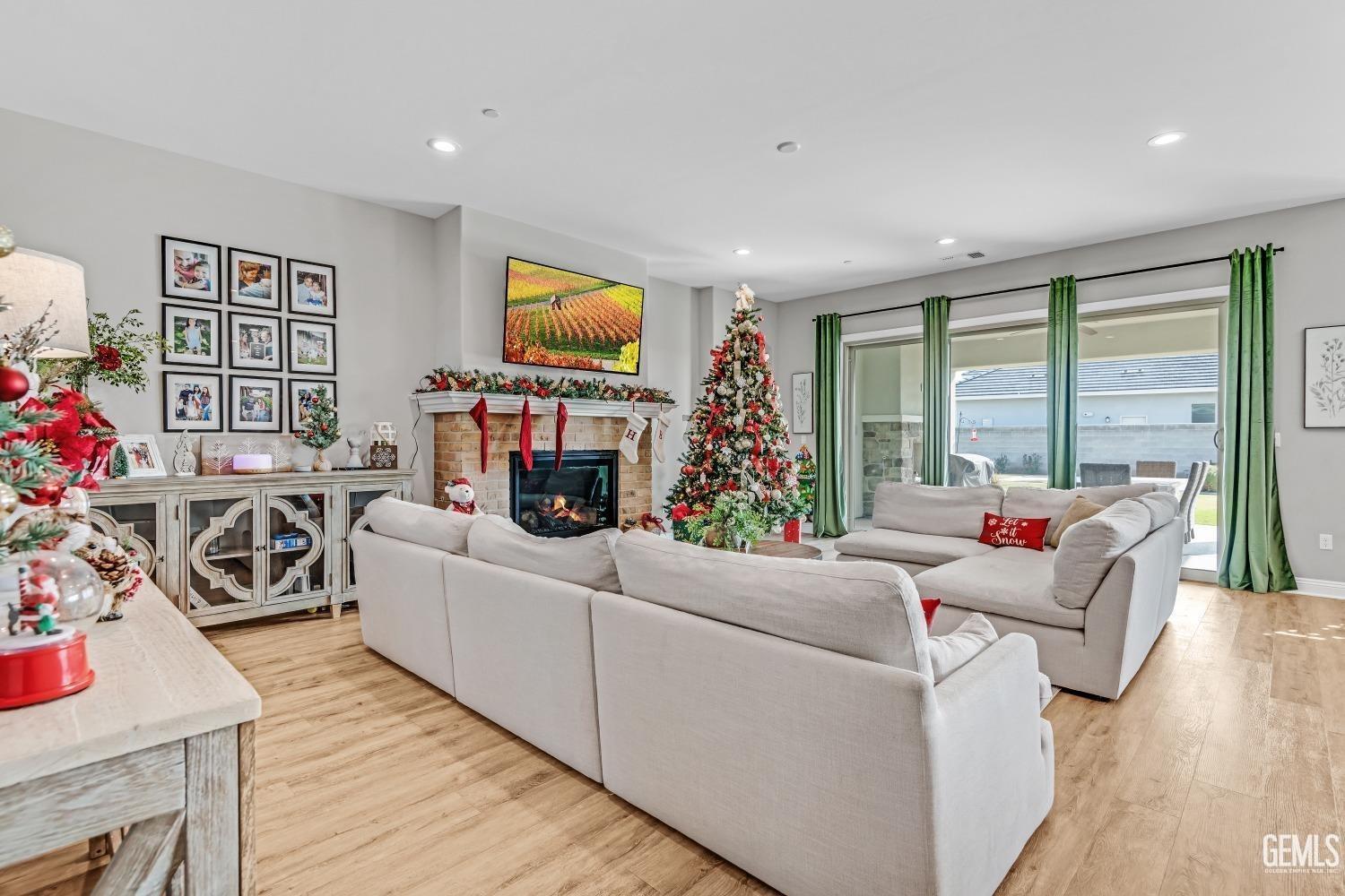 Undisclosed Address Bakersfield, CA 93311 - Photo 17 of 52 a living room with furniture a flat screen tv and a floor to ceiling window