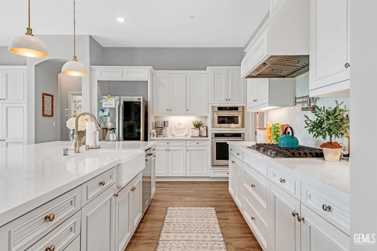 Undisclosed Address Bakersfield, CA 93311 - Photo 23 of 52 a kitchen with cabinets and appliances