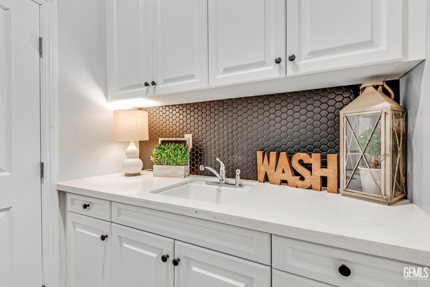 Undisclosed Address Bakersfield, CA 93311 - Photo 27 of 52 a sink with white cabinets