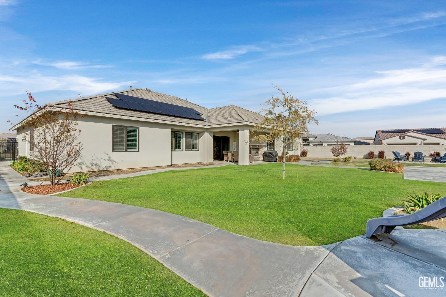 Undisclosed Address Bakersfield, CA 93311 - Photo 3 of 52 a front view of a house with a garden