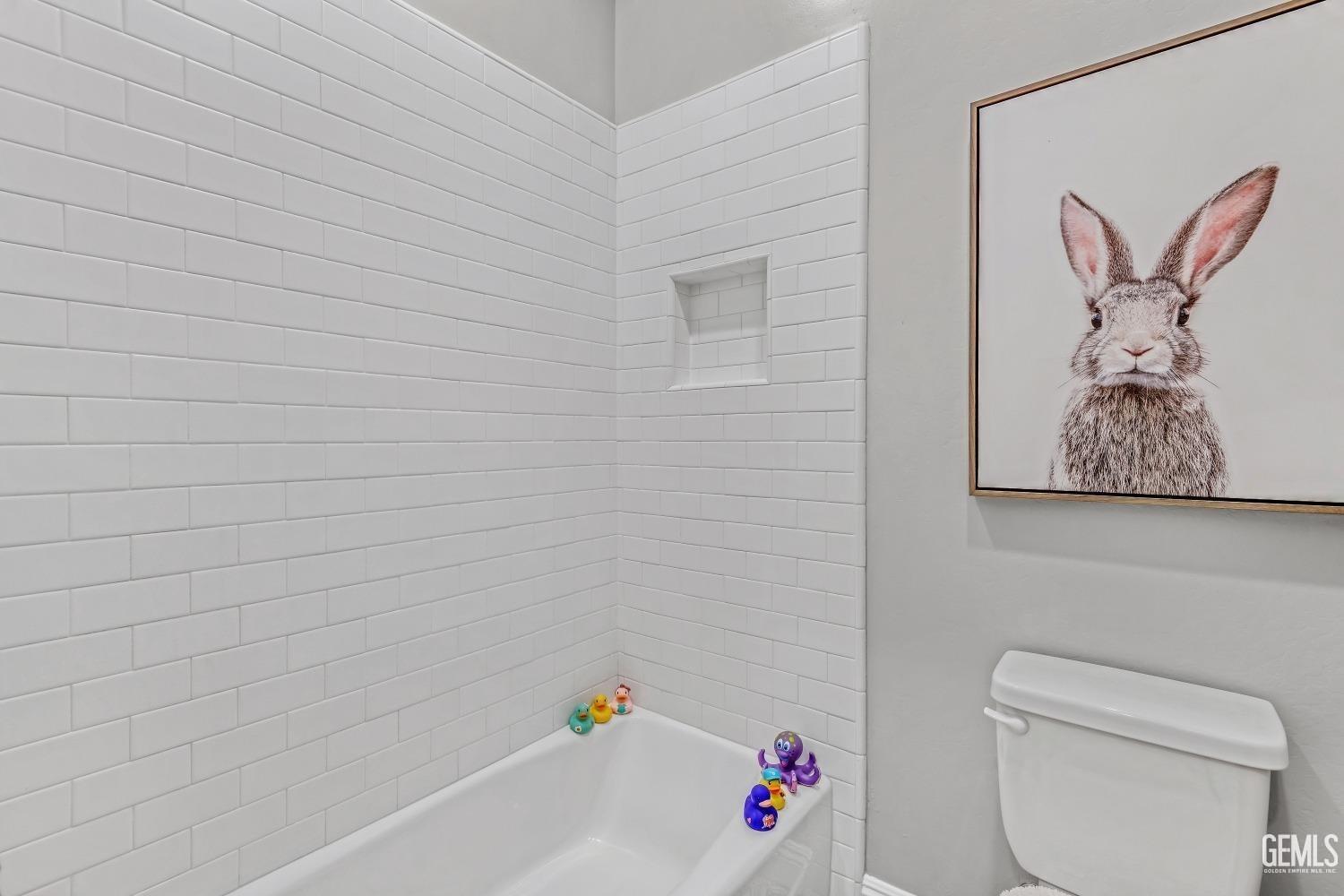 Undisclosed Address Bakersfield, CA 93311 - Photo 40 of 52 a bathroom with a toilet and tub