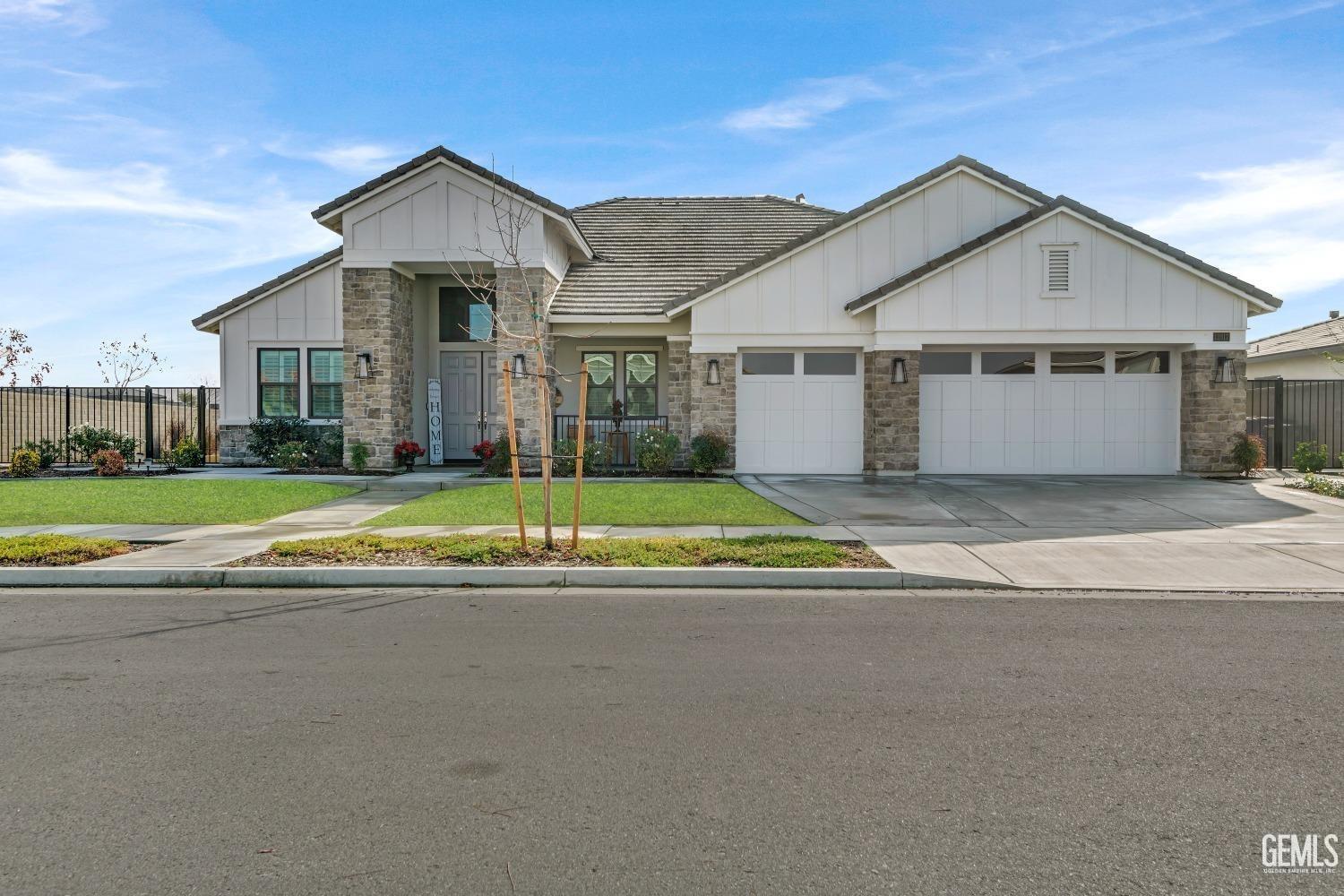 Undisclosed Address Bakersfield, CA 93311 - Photo 6 of 52 a view of a house next to a big yard with large trees