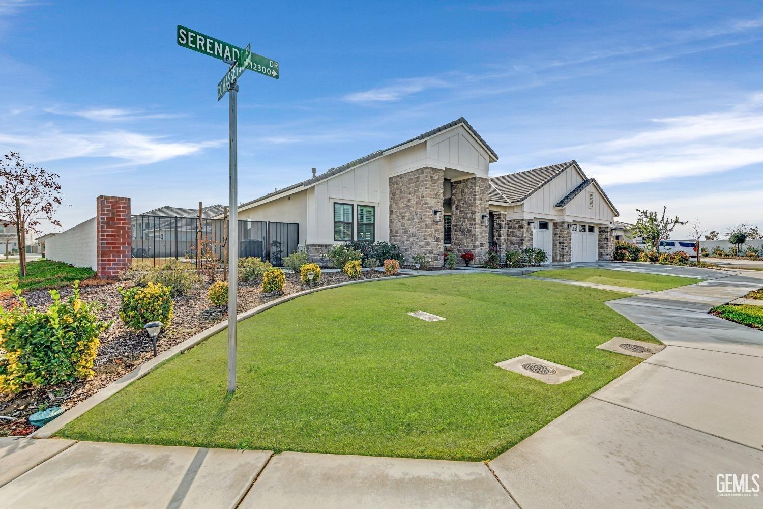 Undisclosed Address Bakersfield, CA 93311 - Photo 7 of 52 a front view of a house with a yard