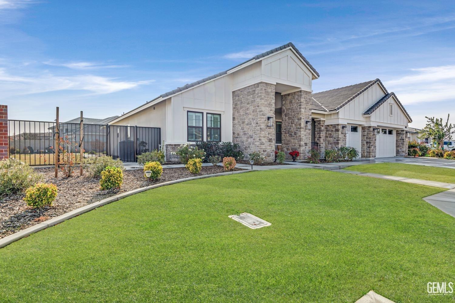 Undisclosed Address Bakersfield, CA 93311 - Photo 8 of 52 a front view of a house with garden