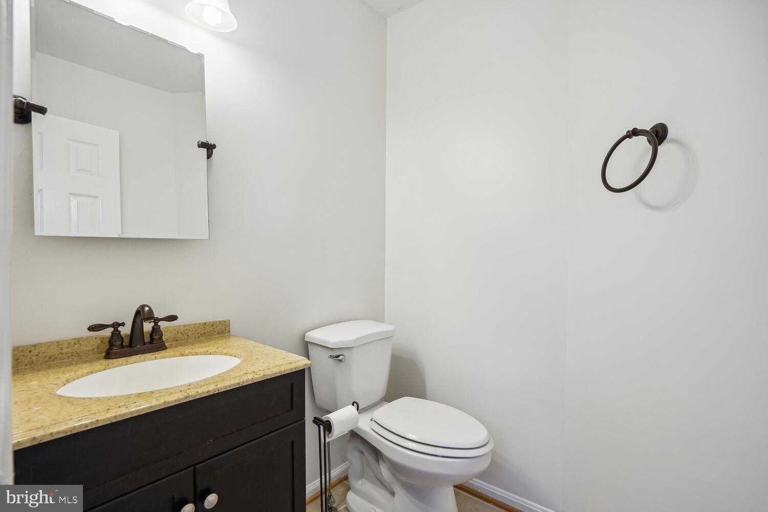 9205 Ridgefield Circle Frederick, MD 21701 - Photo 7 of 19 a bathroom with a sink toilet and mirror