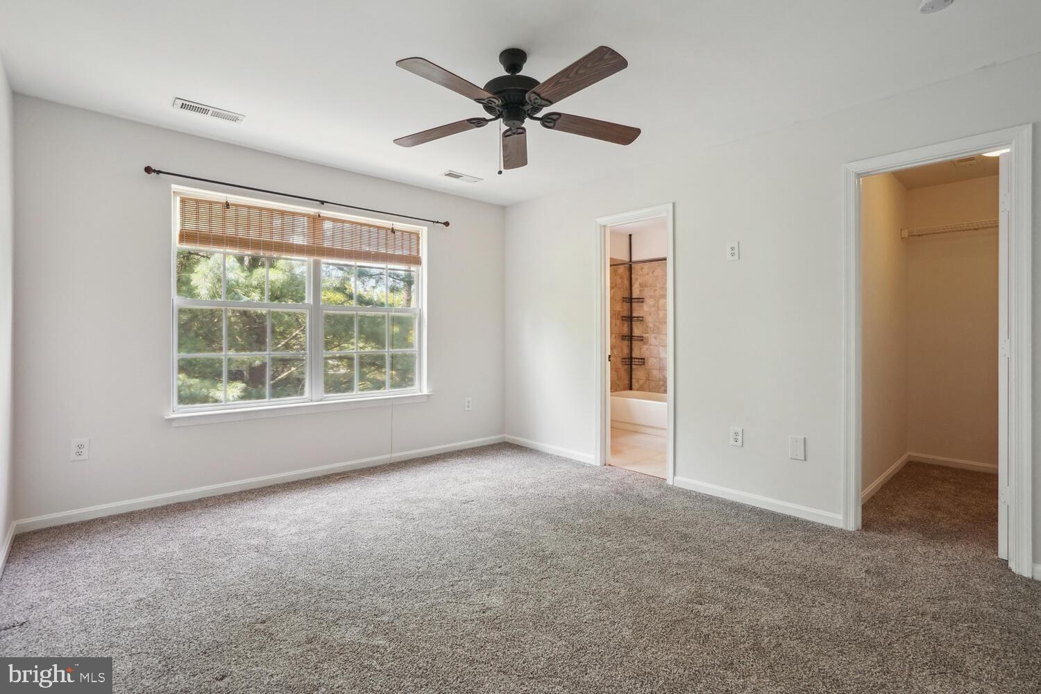 9205 Ridgefield Circle Frederick, MD 21701 - Photo 8 of 19 an empty room with ceiling fan and windows