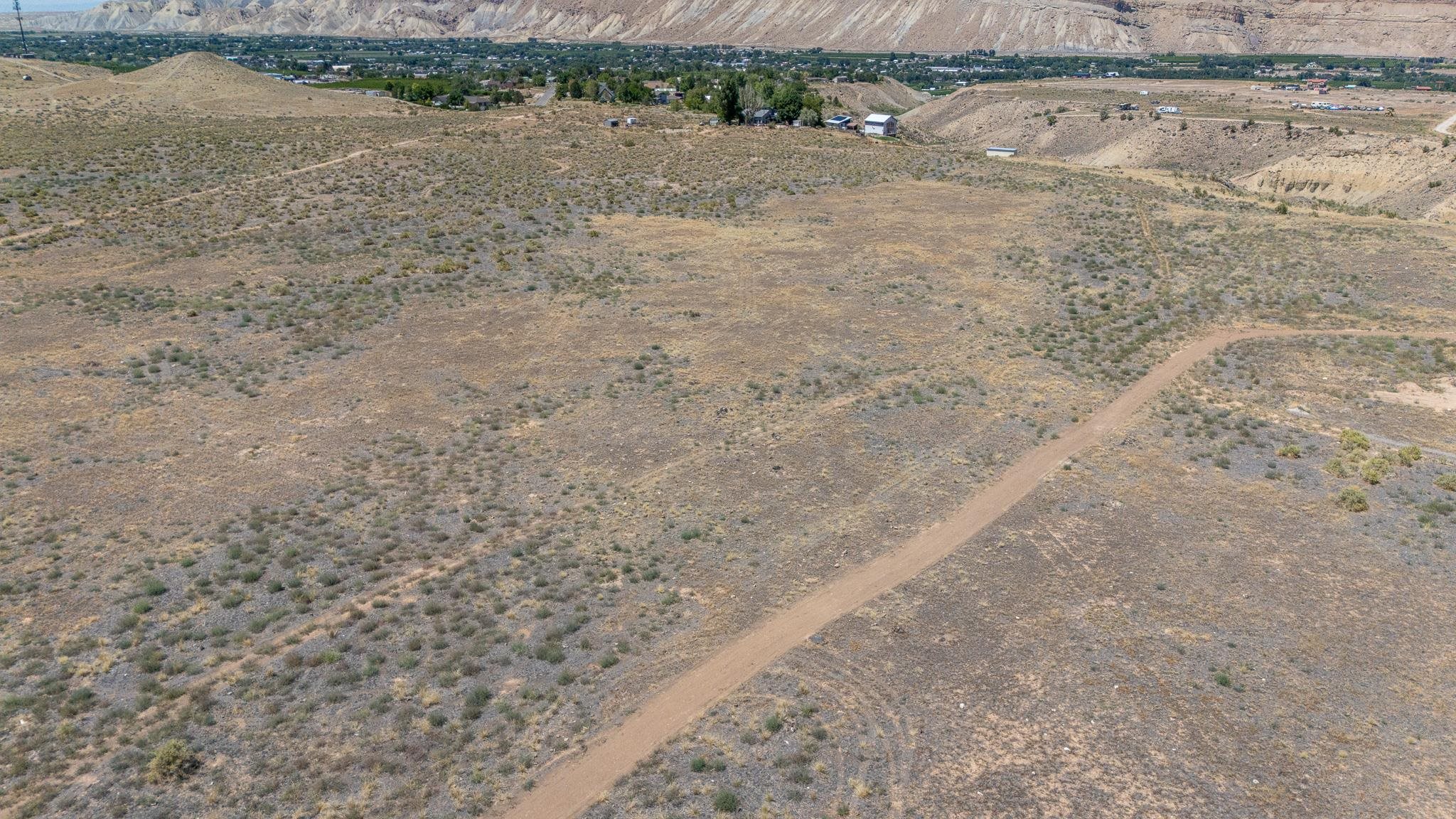 589 39 Road Palisade, CO 81526 - Photo 13 of 40 a view of a dry yard with wooden fence