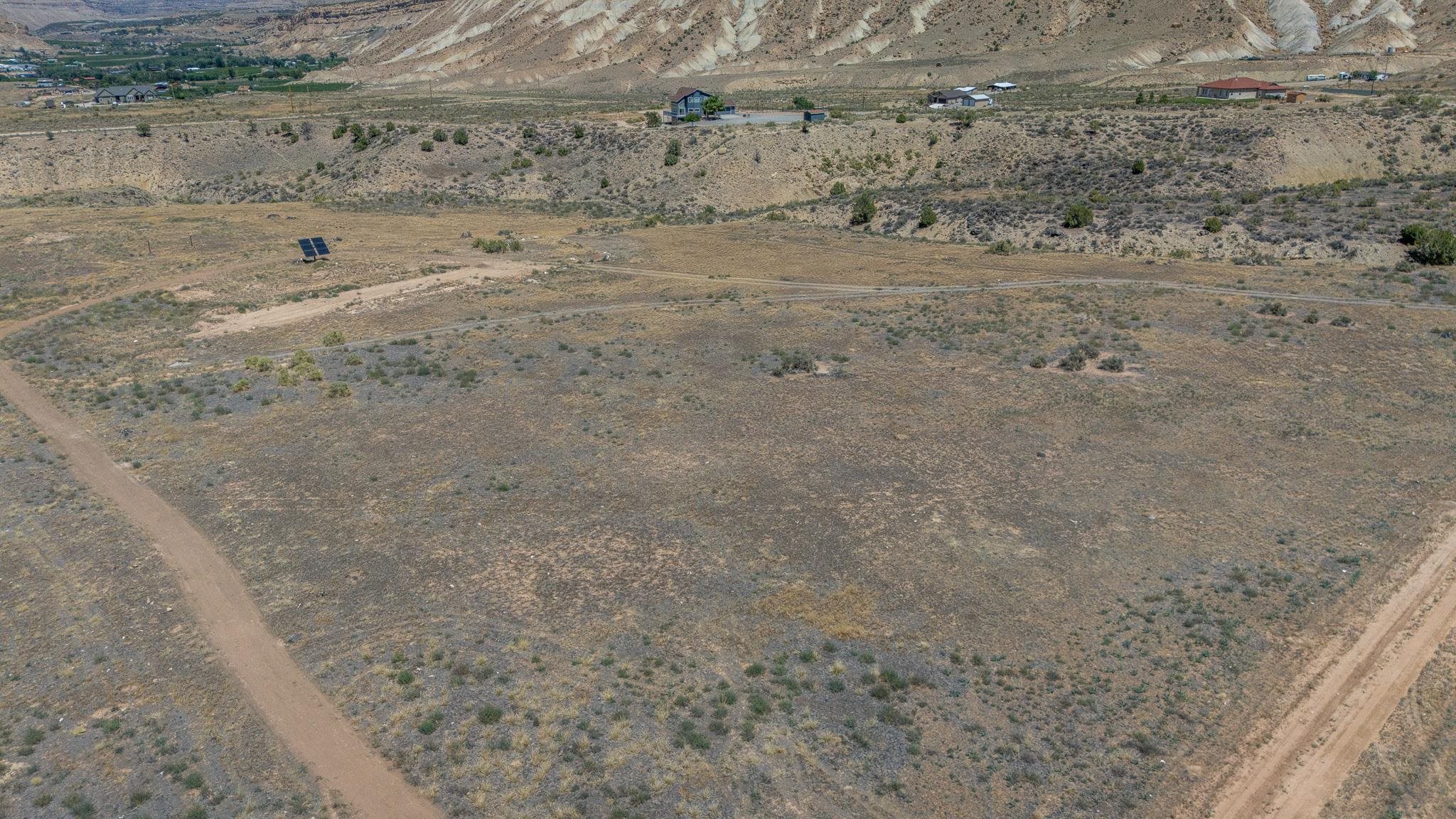 589 39 Road Palisade, CO 81526 - Photo 32 of 40 a view of a dry field with wooden fence
