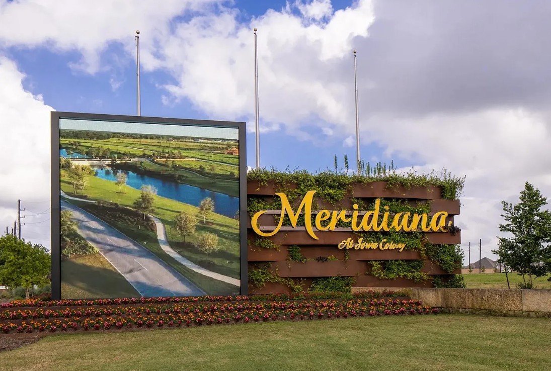 5602 Caracara Street Manvel, TX 77578 - Photo 12 of 15 a sign on a street next to a building