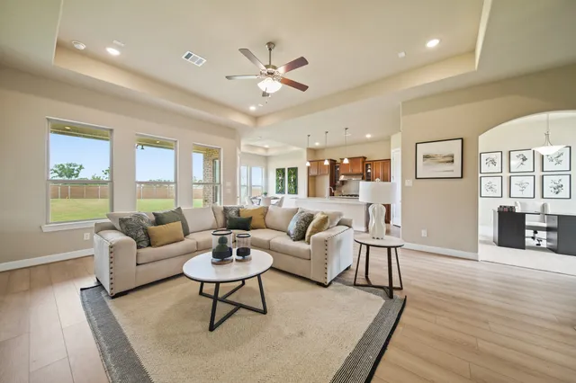 a living room with furniture and wooden floor