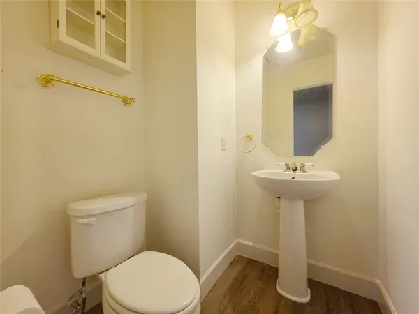 a bathroom with a sink a toilet and mirror