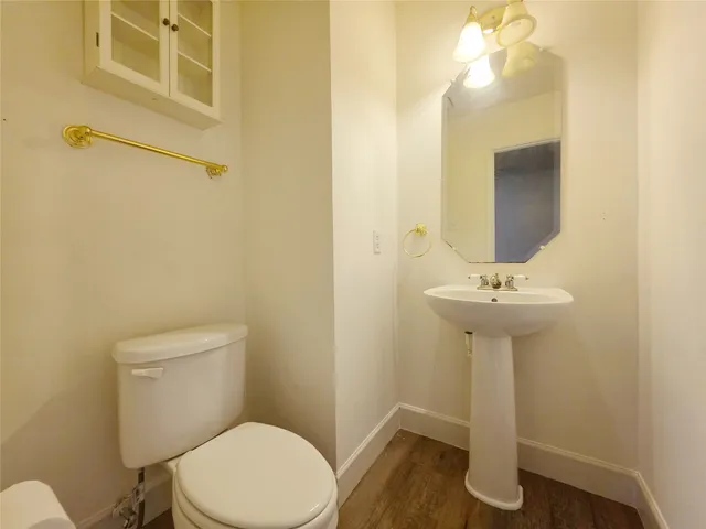 a bathroom with a sink a toilet and mirror