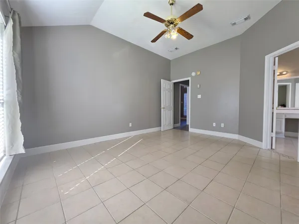 an empty room with closet and a window