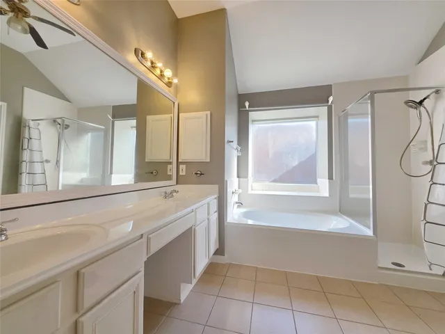 a bathroom with a tub sink and mirror