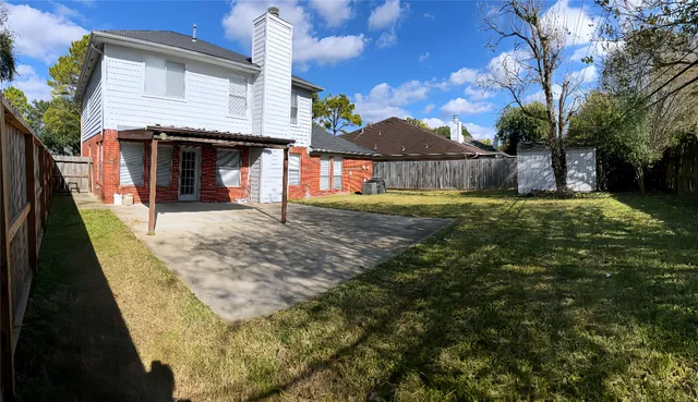 a view of a house with a backyard