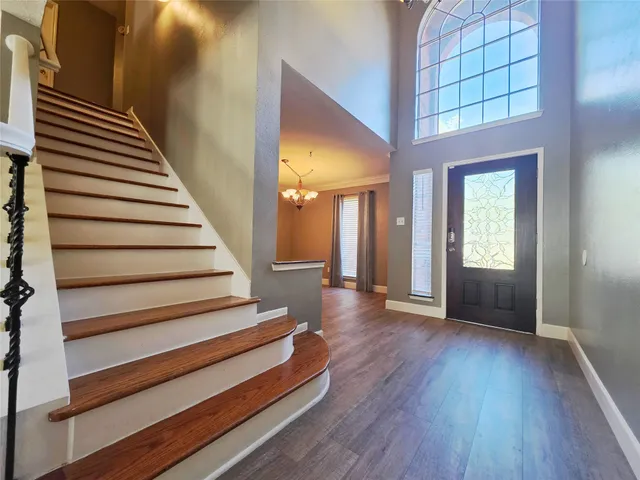 a view of entryway and hall with wooden floor