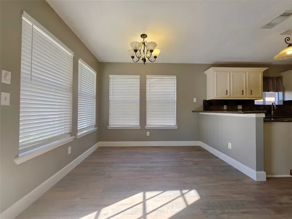 a view of a kitchen with microwave and windows