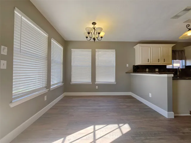 a view of a kitchen with microwave and windows
