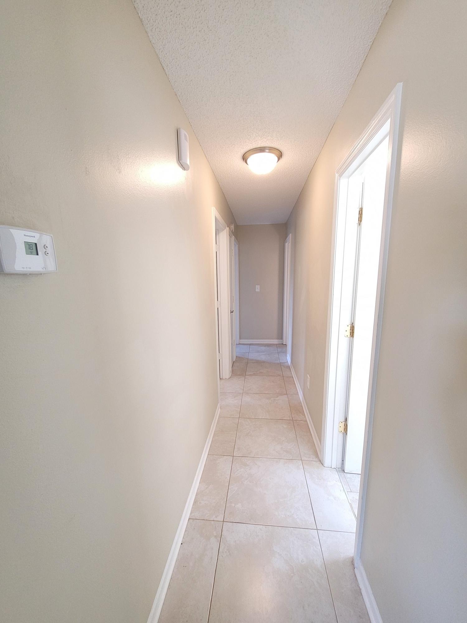 4 Holly Road Crestview, FL 32539 - Photo 14 of 30 a view of hallway with a window and a bathroom