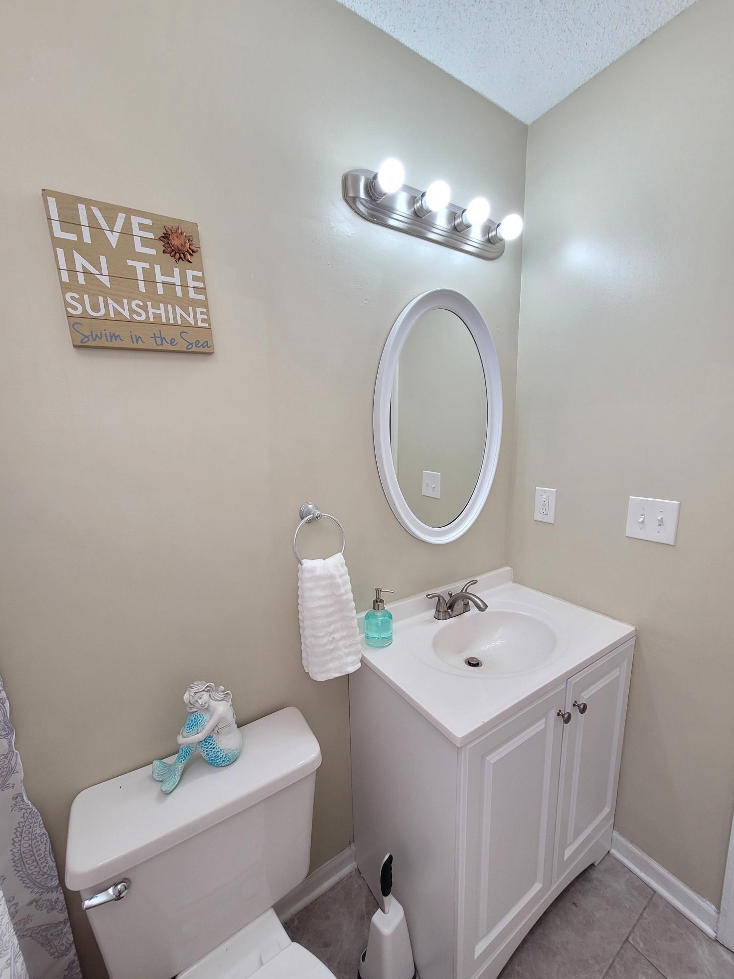 4 Holly Road Crestview, FL 32539 - Photo 16 of 30 a bathroom with a toilet sink and mirror