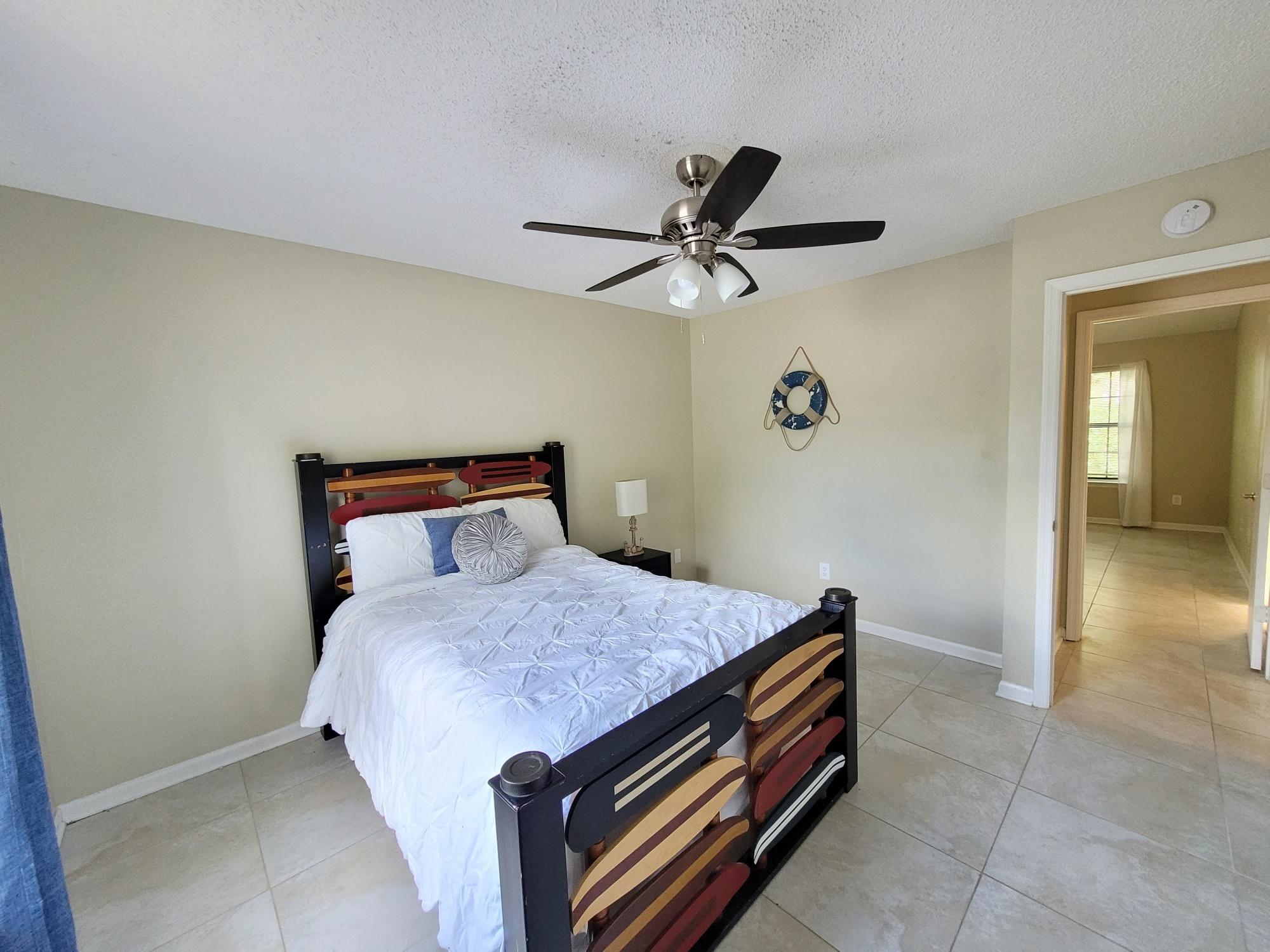 4 Holly Road Crestview, FL 32539 - Photo 21 of 30 a bedroom with a bed and a chandelier