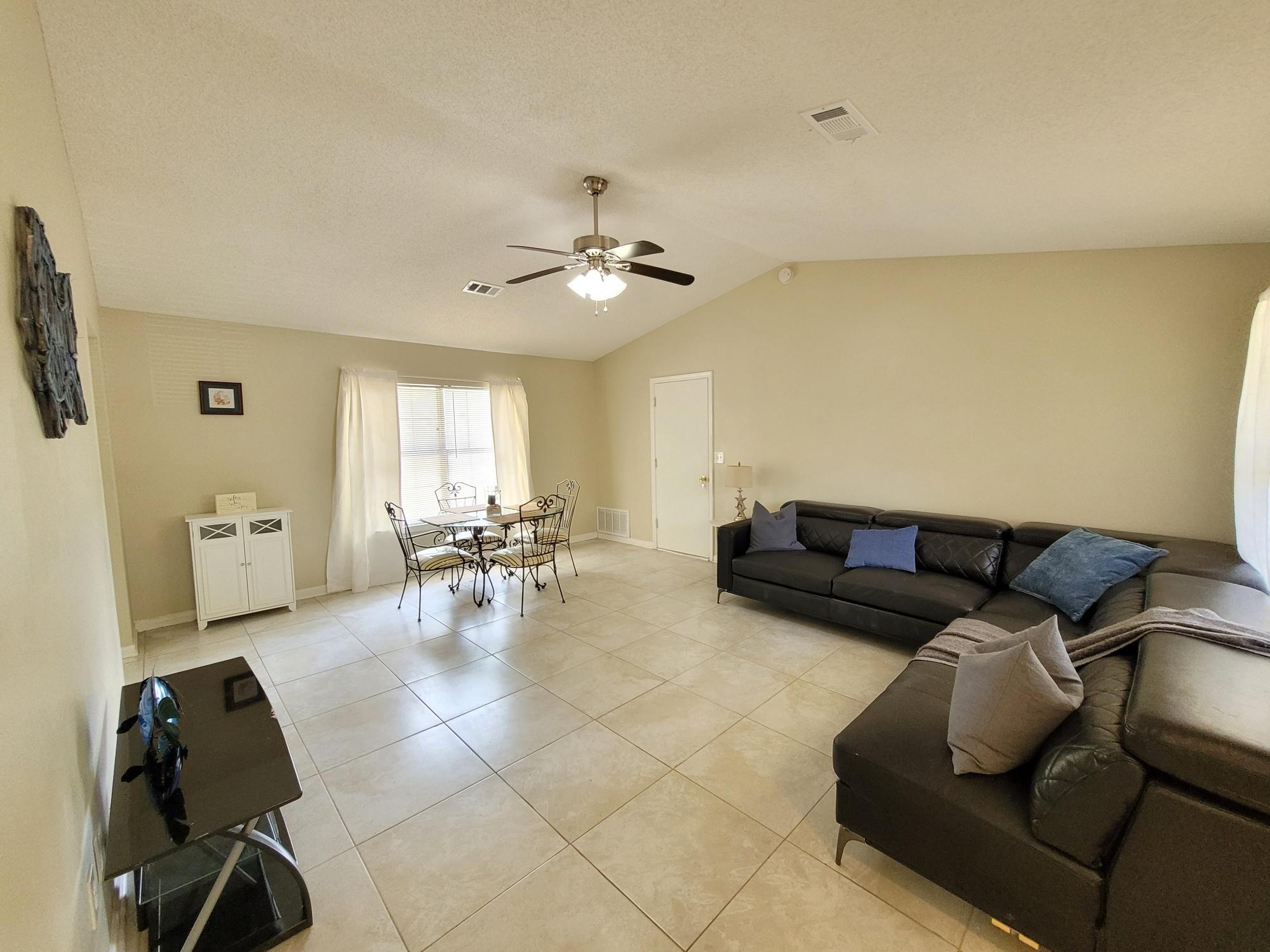 4 Holly Road Crestview, FL 32539 - Photo 5 of 30 a living room with furniture and a chandelier