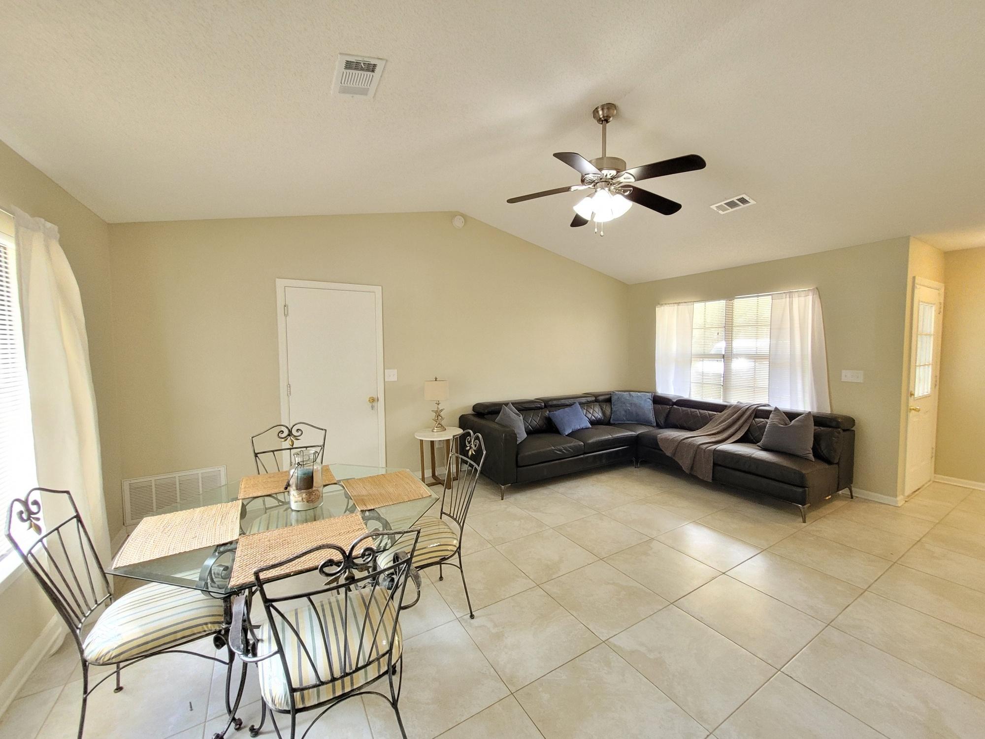 4 Holly Road Crestview, FL 32539 - Photo 6 of 30 a living room with furniture and a chandelier