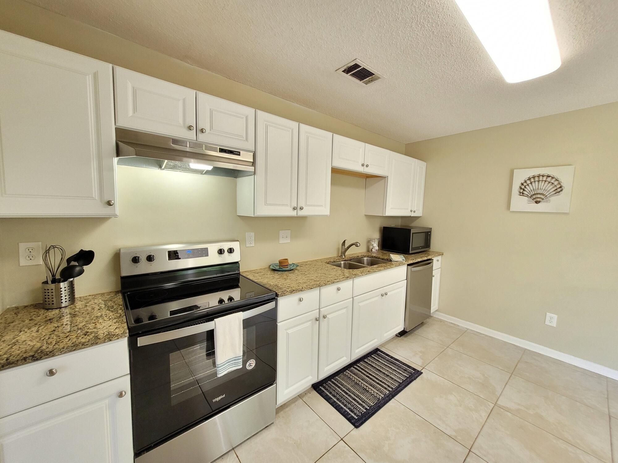 4 Holly Road Crestview, FL 32539 - Photo 10 of 30 a kitchen with cabinets and appliances