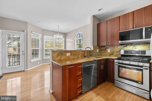 a kitchen with wooden cabinets and stainless steel appliances