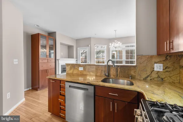 a kitchen with granite countertop a stove and a sink